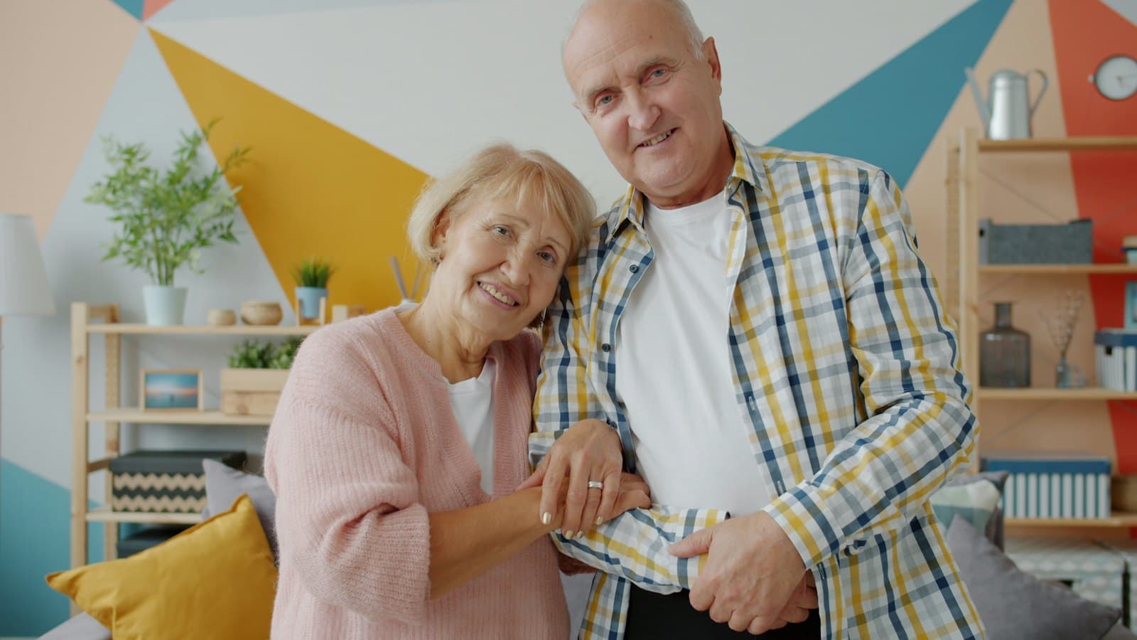 An older couple relaxing in a bright living room