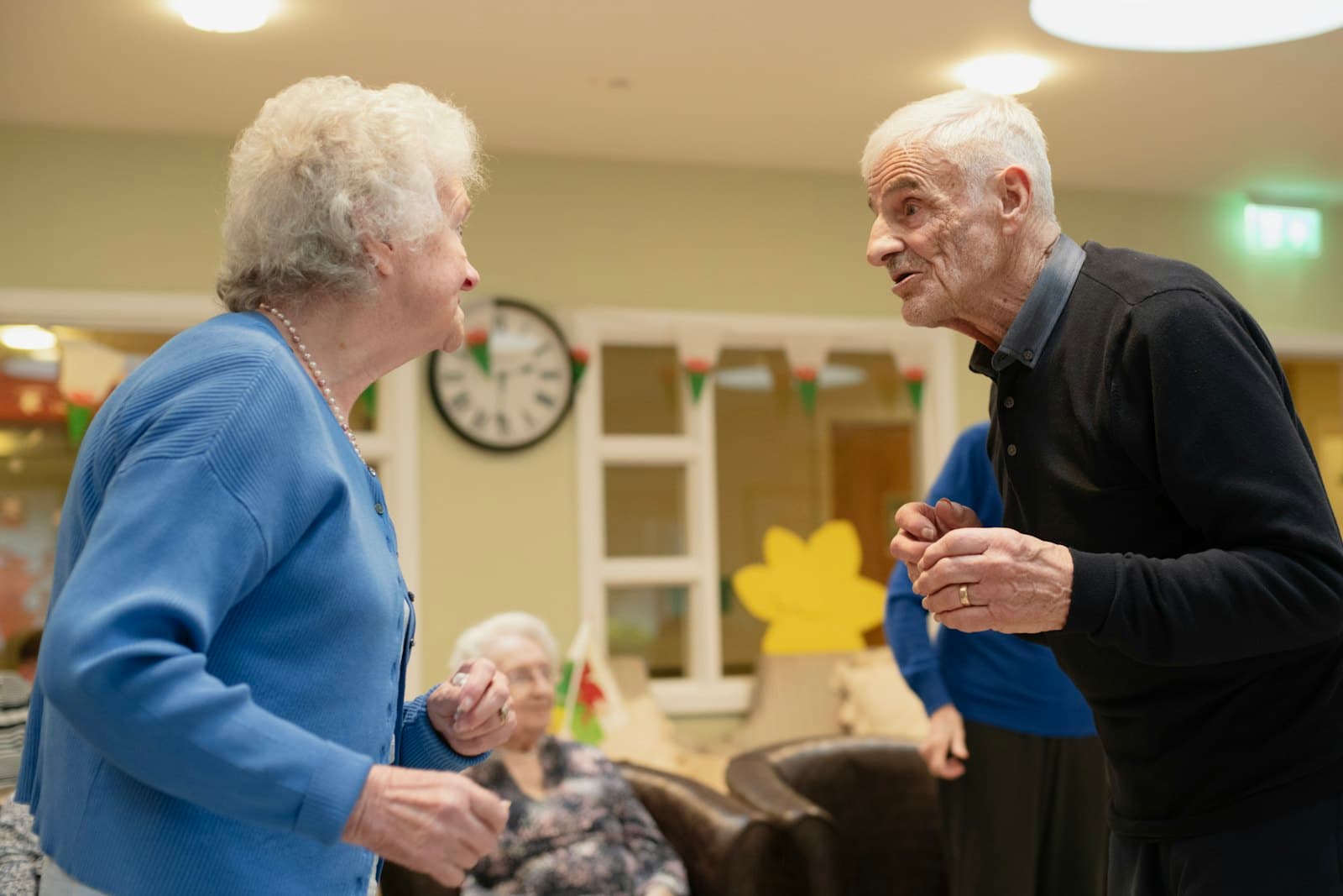 An older couple talking together in a sitting room
