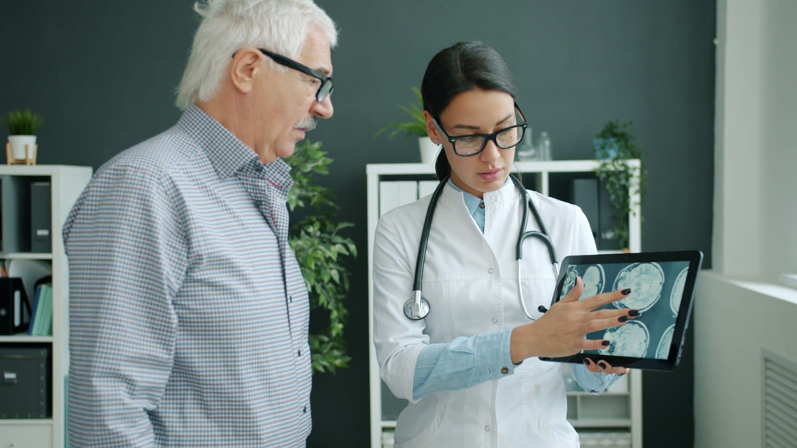 A doctor showing an older man results on a tablet