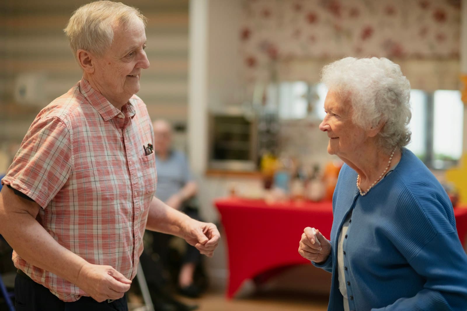 An older couple dancing at a social in their residence